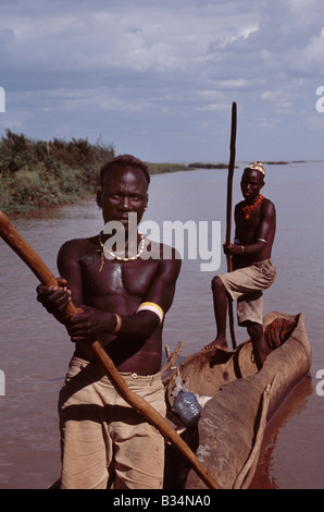 Kenya, Omo Delta, Lake Turkana. El Molo fishermen in their dugout canoe on the fringe of the Omo Delta. The El Molo are reputedly Kenya's smallest tribe, a group of nomadic fishermen who fish the Omo delta and Lake turkana. Stock Photo