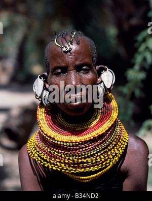 Kenya, Northern Frontier District, Loyangalani. An old Turkana woman, typically wearing many layers of bead necklaces and a series of hooped earrings with an pair of leaf-shaped earrings at the front. Stock Photo
