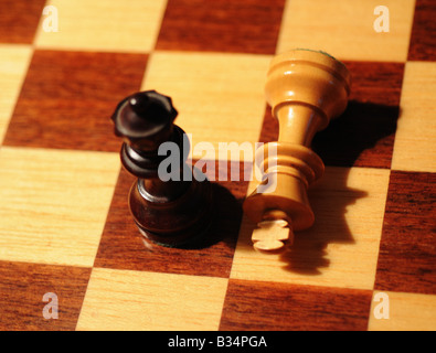 Close-up, detailed images of various chess pieces, queen, king, paws, black and white on a chessboard, resign defeat, checkmate Stock Photo