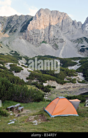 Tourist tent at Sinanitsa lake and Momin peak in background in World Heritage Site Pirin National Park Bulgaria Stock Photo