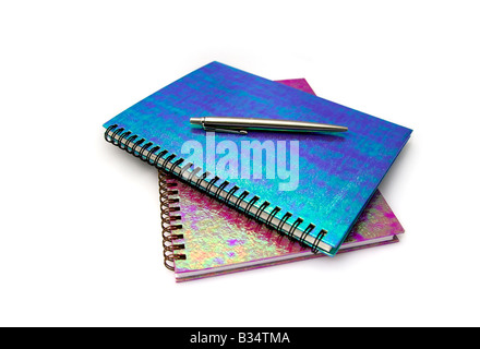 Spiral bound notebooks and pen, white background Stock Photo