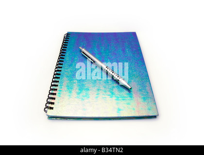 Spiral bound notebook and pen, white background Stock Photo