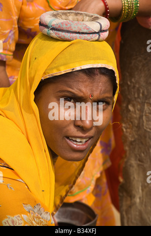 A BANJARI TRIBESWOMAN at the water well in her village in the THAR DESERT near JAISALMER RAJASTHAN INDIA
