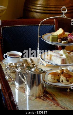 Peninsula Hotel Hong Kong. Afternoon tea. luxury hotel. Tea in the lobby of the Peninsula Hotel.  Cakes, scones and Sandwiches Stock Photo