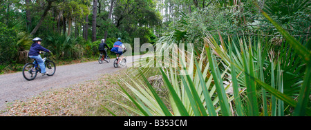 Family riding bikes on Pinckney Island National Wildlife Refuge, Hilton Head, South Carolina Stock Photo