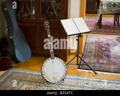 BANJO RESTING ON STAND AND SCORE IN LIVING-ROOM Stock Photo