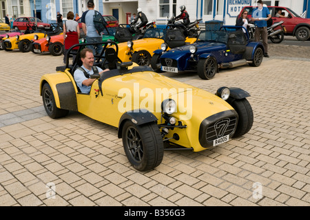 man driving Lotus Caterham 7 classic british motor car supporters club rally on the promenade in Aberystwyth Wales UK Stock Photo