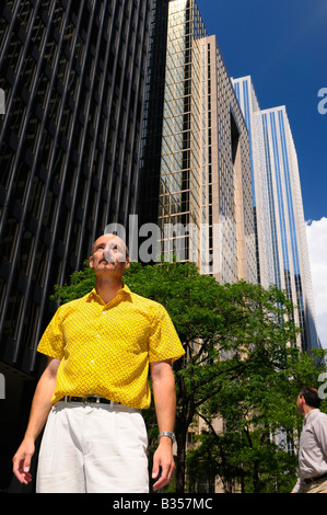 Man looking up at skyscraper high rise towers in downtown financial district of Toronto in summer Stock Photo