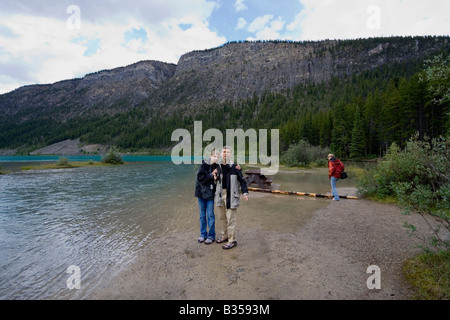 family walking on the bank of the mistaya river - banff national park, canada Stock Photo