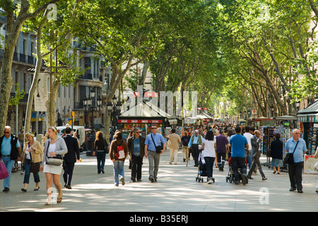 SPAIN Barcelona People strolling down the Ramblas pedestrian walkway in the heart of the city popular tourist destination Stock Photo