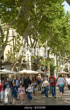 SPAIN Barcelona People strolling down the Ramblas pedestrian walkway in the heart of the city popular tourist destination Stock Photo