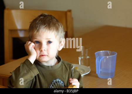 Boy eating dinner in a nursery school in Berlin, Germany Stock Photo