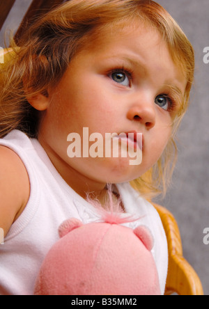 Close-up girl child with a toy, on white background Stock Photo - Alamy