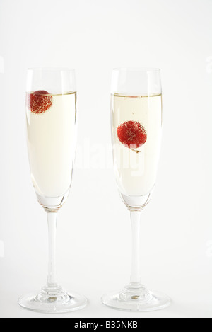 Champagne with cherries in glasses Stock Photo