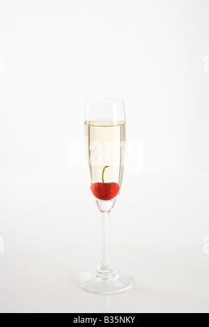 Cherry floating in glass of champagne Stock Photo