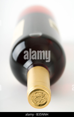 Wine bottle lying on its side, focus on bottle seal Stock Photo