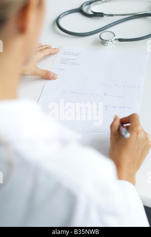 Doctor writing prescription, over the shoulder view, cropped Stock Photo