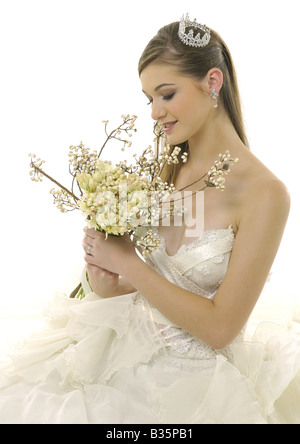 Bride sitting down with bouquet on her dress in black and white Stock ...