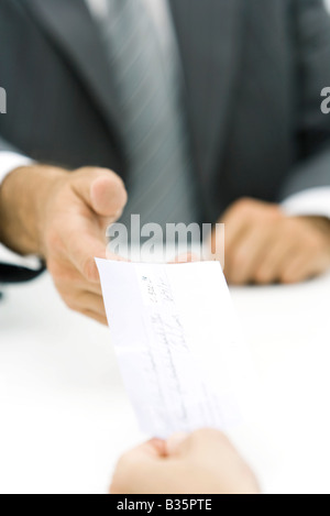 Businessman accepting check, cropped view of hands Stock Photo