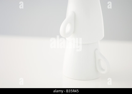 Two mugs stacked upside down, close-up Stock Photo