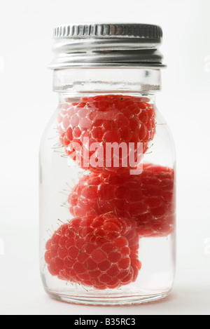 Raspberries in small jar, close-up Stock Photo
