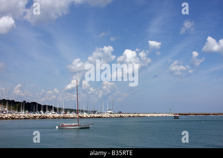 A sailing boat leaving the harbor area at the Maritime Festiville in Port Washington Wisconsin Stock Photo