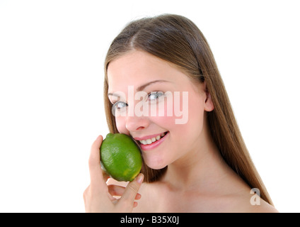 Portrait of a young woman holding a lime and smiling Stock Photo