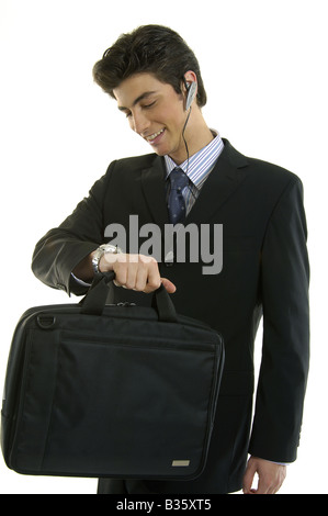 Businessman checking the time in his wristwatch and smiling Stock Photo
