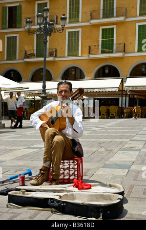 A crippled man plays the guitar in the centre of Placa Major, Palma de Majorca Stock Photo