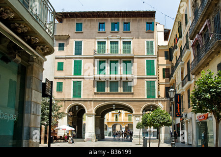 Green shuttered doors and balconies above arches in old town, Placa Major Palma de Mallorca Stock Photo