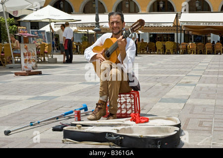 Guitarist with crutches entertaining in the centre of Placa Major, Palma de Mallorca Stock Photo