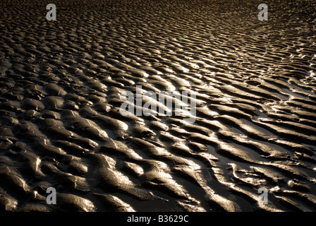 Detail of wet rippled sand on Talacre Beach in North Wales photographed at Sunset. Stock Photo