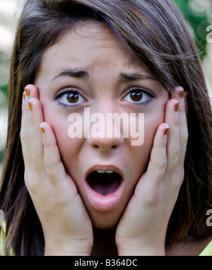 A 16 year old pretty caucasian girl shows a facial expression of shock and surprise. Stock Photo