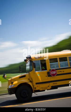 School bus driving down the road with motion blur. Stock Photo