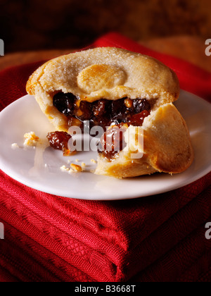 Close up of fresh cooked mincemeat mince pies broken open in a festive setting Stock Photo