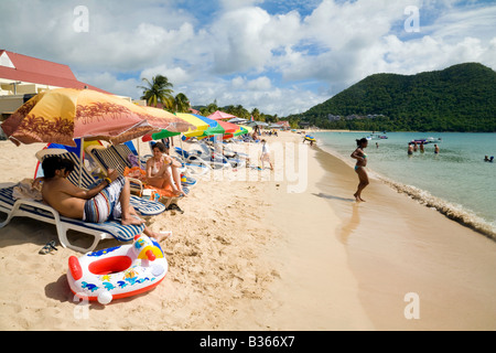 Tourists enjoy the sunshine on Reduit beach, St Lucia, West Indies Stock Photo