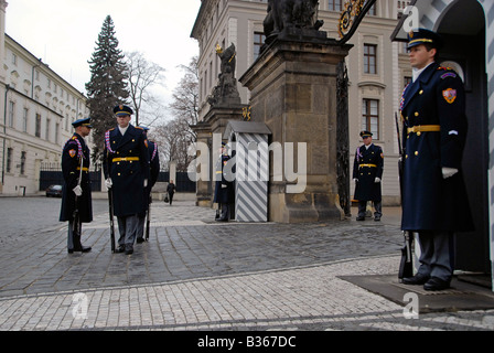 Castle guards stand firm during changing of guards process at the main entrance to Prague Castle in Czech republic