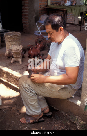 Mexican male artisan making replicas of pre-Hispanic ceramic figurines in the city of Colima, Mexico Stock Photo