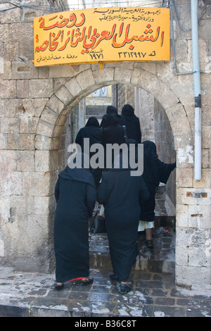 Muslim Women Wearing Chadors Going Upstairs in the Old City in Aleppo Syria Stock Photo
