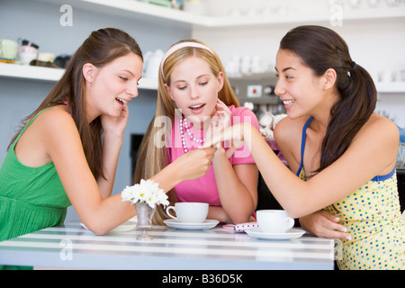 Young woman showing off engagement ring to friends Stock Photo