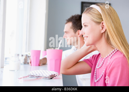Young couple having a cold drink in a cafeteria Stock Photo