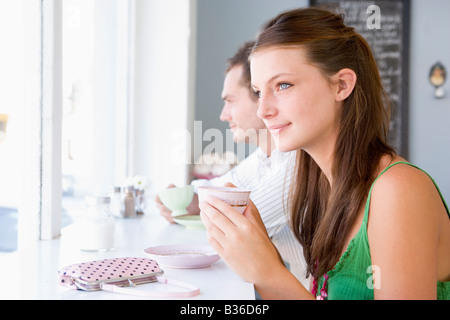 Young couple having tea in a cafeteria Stock Photo