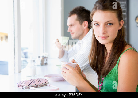 Young couple having tea in a cafeteria Stock Photo