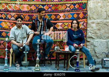 Young Syrian Men Smoking Nargilehs in the Old City in Damascus Syria Stock Photo