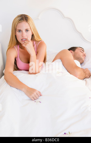 Young couple in bed having trouble sleeping Stock Photo