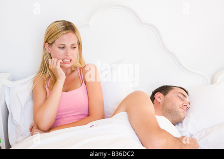 Young couple in bed having trouble sleeping Stock Photo