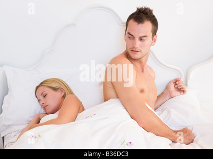 Young couple in bed having trouble sleeping Stock Photo