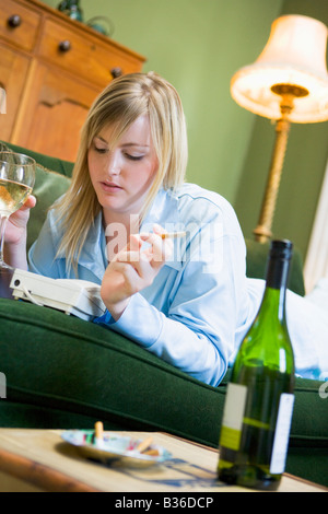 Young woman at home waiting by telephone Stock Photo