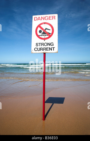 A danger sign in the shallow waves on Manley Beach close to Sydney in Australia.
