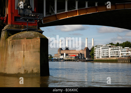 View along the River Thames to Battersea Power Station seen from under one of the arches of Vauxhall Bridge, London Stock Photo